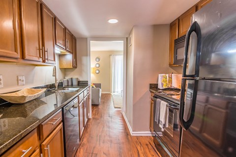 a kitchen with wooden cabinets and stainless steel appliances